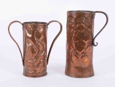 Two Art Nouveau copper jugs embossed decorated with flowers, tallest 27cm