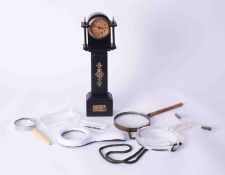 A mini Longcase clock together with five magnifying glasses.