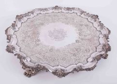A large silver plated salver with chased decoration and central shield engraving, gadrooned border