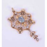 An Edwardian gold (not tested) flower & leaf design pendant set seed pearls & oval cut aquamarine,