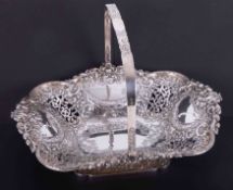 A good Victorian silver cake basket with repousse decoration and swing handle, maker Henry