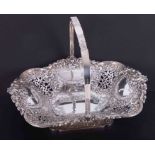 A good Victorian silver cake basket with repousse decoration and swing handle, maker Henry
