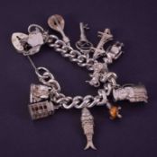 A curb style heavy gauge silver charm bracelet, padlock safety chain fitted, maker R&S, circa