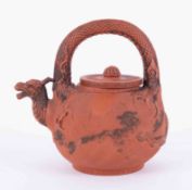 A Chinese terracotta teapot with dragon spout, height 23cm.