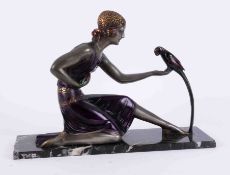 An Art Deco style sculpture, after D.H.Chiparus, a seated lady holding a parrot, 47cm x 15cm