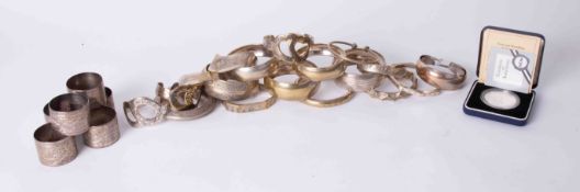 A collection of mixed ornate metal bangles, also six engraved Eastern napkin rings, Falkland Islands