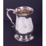 A Georgian silver plain baluster shaped tankard hallmarked London, indistinct hallmarks, possibly