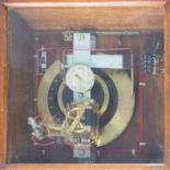 The Synchronome, a brass dial clock in oak cabinet, overall size 54cm x 56cm.