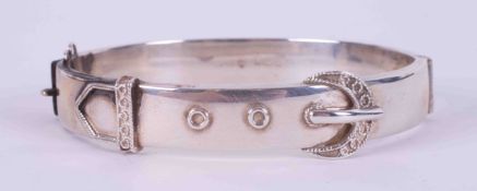 A silver hinged buckle design bangle, safety chain missing, 16.51g.