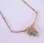 A 9ct yellow gold necklace with a figaro style chain set with four marquise cut emeralds and seven