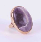 A 9ct yellow gold ring set with a large oval cabochon cut tumbled banded amethyst stone, approx.,