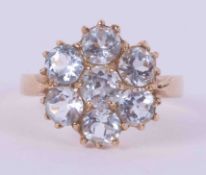 A 9ct yellow gold flower design ring set with blue paste round cut cubic zirconia stones, 3.53g,