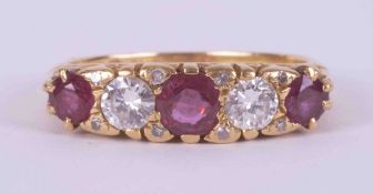 An antique 18ct yellow gold five stone ring set with three round cut rubies, approx. 0.60 carats and