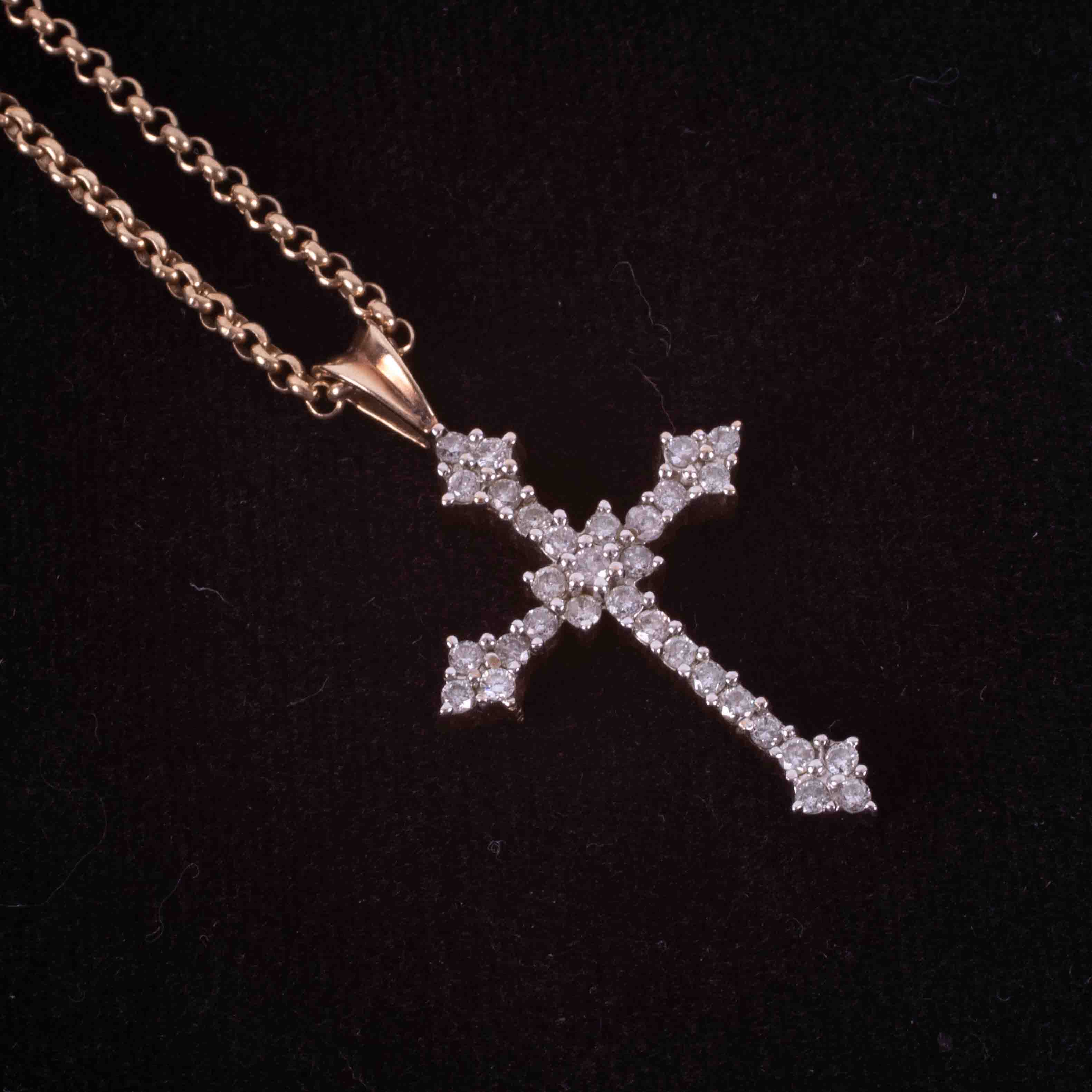 A 9ct yellow gold 16" belcher chain with a 9ct yellow gold cross set with approx. 0.75 carats of