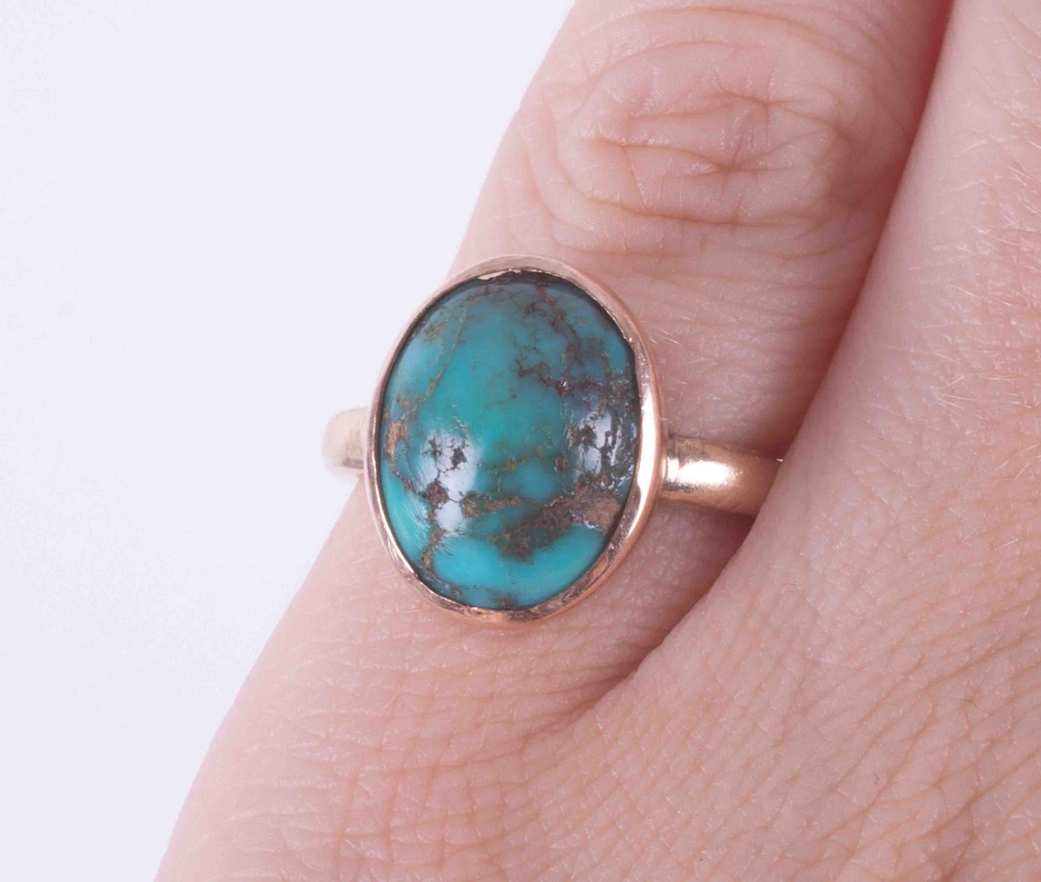 A 9ct yellow gold ring set with a cabochon cut turquoise, approx. 12.5mm x 9.5mm, 3.76g, size J. - Image 2 of 2