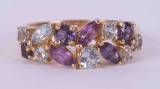 A 9ct yellow gold ring set with a mixture of round cut & marquise cut gemstones including