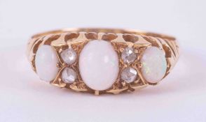 An antique 18ct yellow gold ring set with three oval white opals and four small round old cut