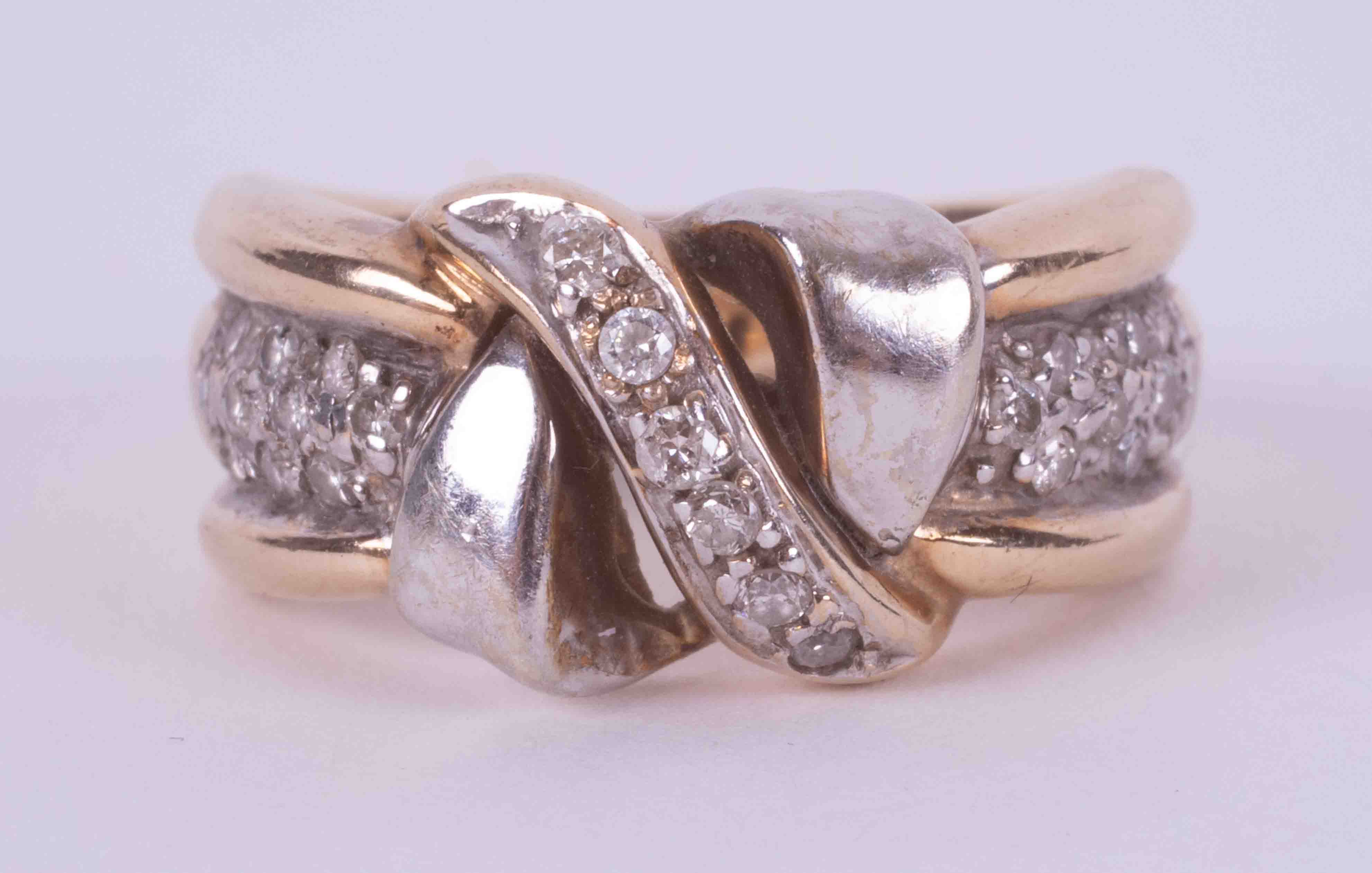 A 9ct yellow & white gold crossover design band set with small round brilliant cut diamonds, 6.