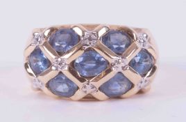 A 9ct yellow & white gold wide band set with seven oval cut sapphires, approx. 2.45 carats set in