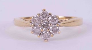 An 18ct yellow & white gold flower cluster ring set with approx. 0.50 carats of round brilliant