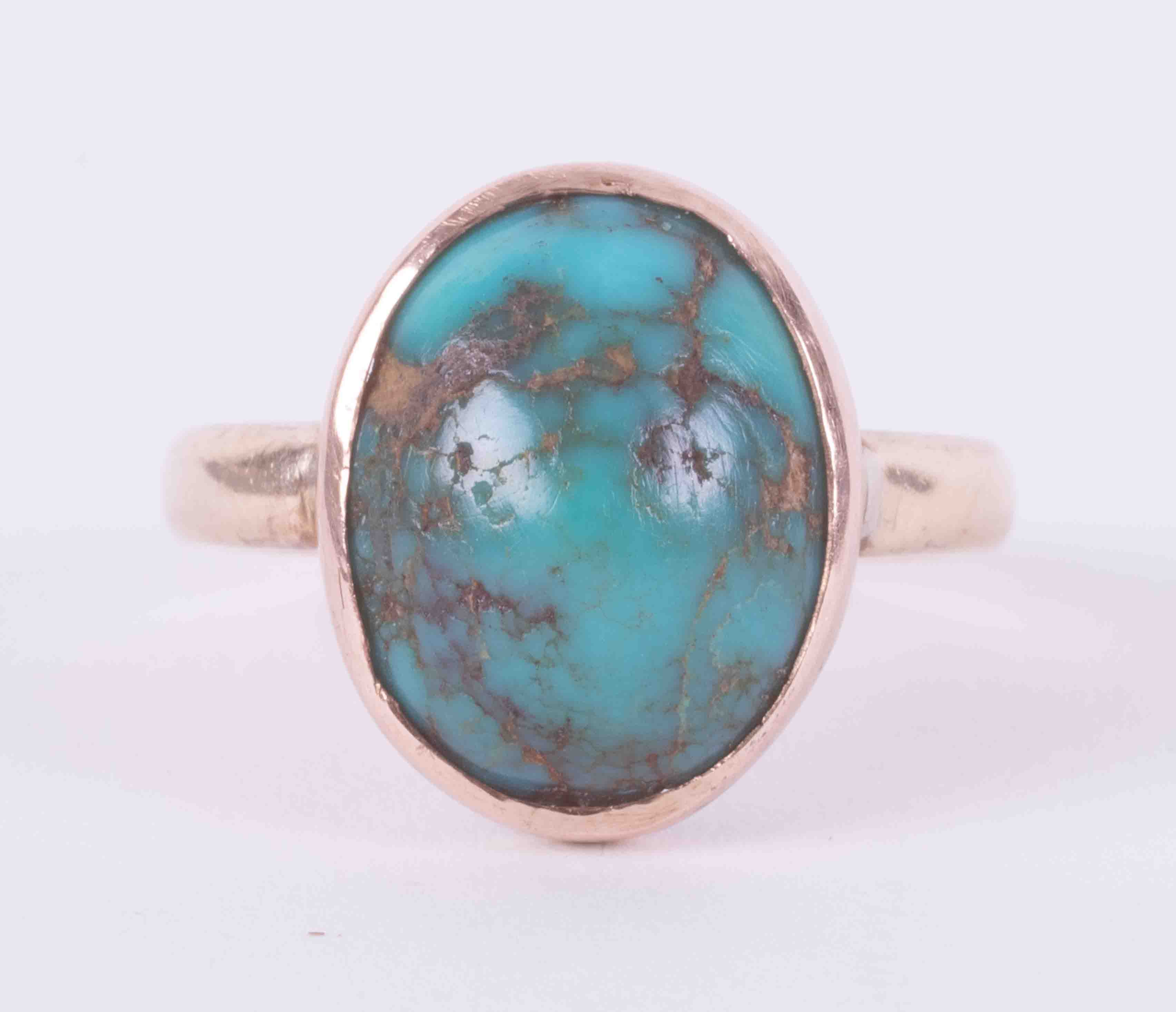 A 9ct yellow gold ring set with a cabochon cut turquoise, approx. 12.5mm x 9.5mm, 3.76g, size J.