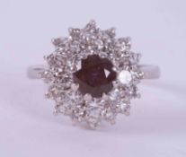 An 18ct white gold cluster ring set with a round cut rubellite (tourmaline)? approx. 0.75 carats,