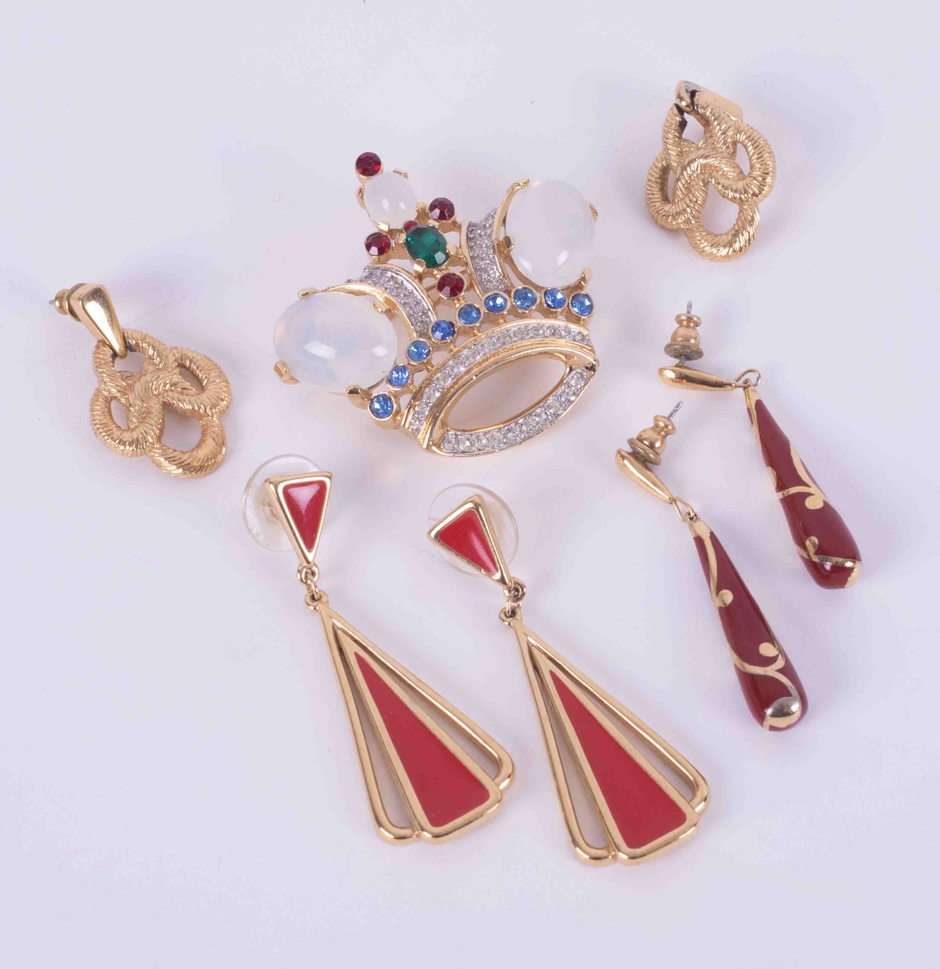 A set of four designer costume jewellery items by Trifari including an ornate paste gem set crown