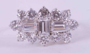 A 9ct white gold cluster style ring set with a mixture of round cut & emerald cut crystals, 3.88g,