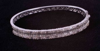 An 18ct white gold bangle set with approx. 4.45 carats of baguette cut & round brilliant cut