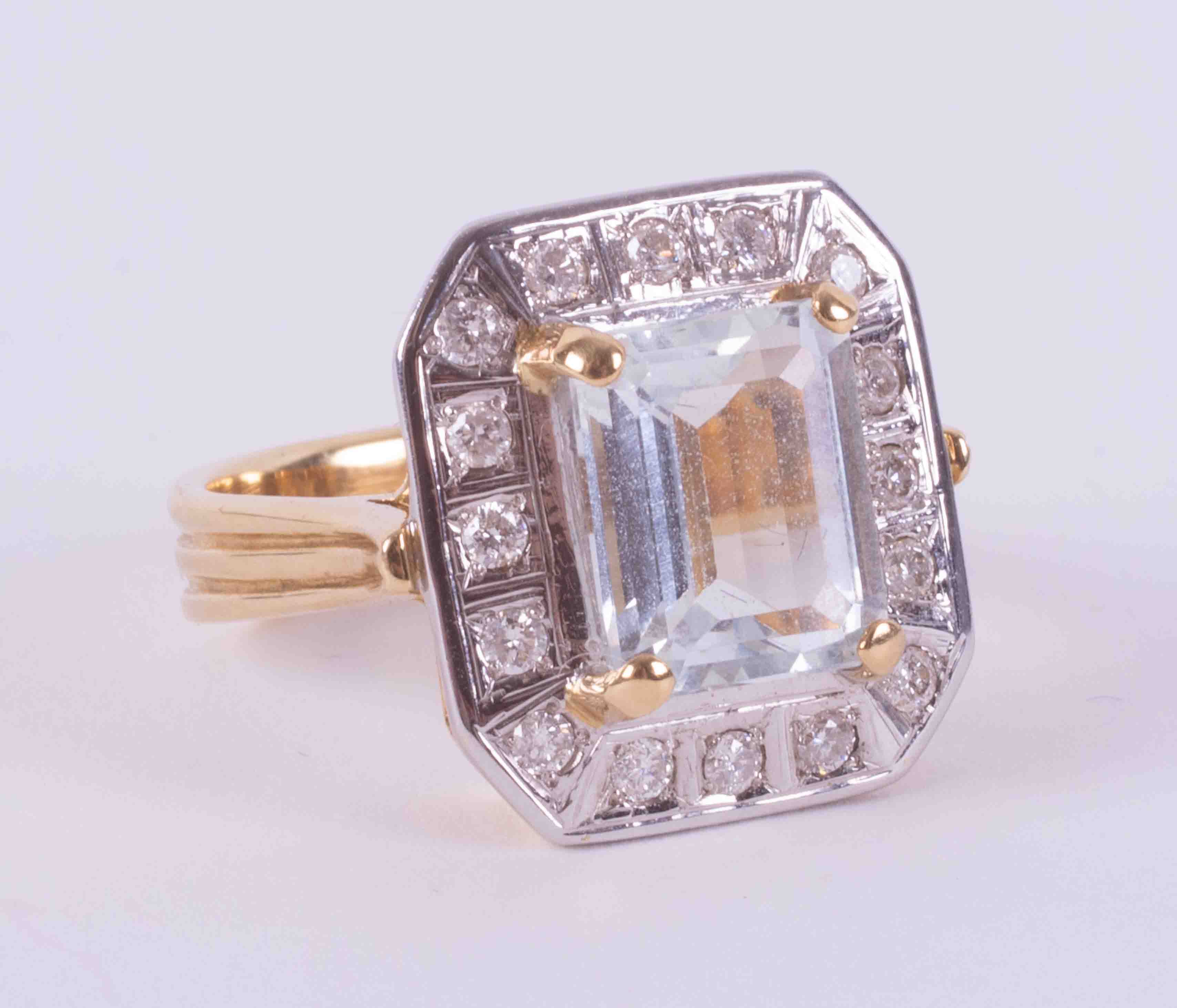 18ct yellow & white gold cluster style ring set with an emerald cut aquamarine, approx. 3.79 carats,