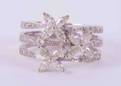 A 14k white gold three row flower design ring set with a mixture of marquise cut and round brilliant