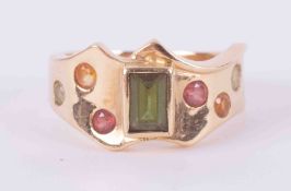 An 18ct yellow gold wave design ring set with green & pink tourmaline, peridot & citrine?, 6.36g,