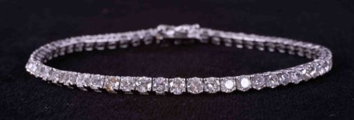 An 18ct white gold line bracelet set with 58 round brilliant cut diamonds, total weight approx. 5.80