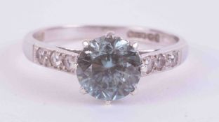 A 9ct white gold ring set with a central round cut blue zircon approx. 1.50 carats with three