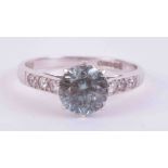 A 9ct white gold ring set with a central round cut blue zircon approx. 1.50 carats with three