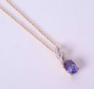 A 9ct yellow gold pendant set oval cut 0.87 carat tanzanite and 0.06 carats of round brilliant cut