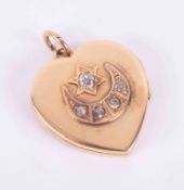 An antique 18ct yellow gold heart locket with a star and moon design set with five old round cut