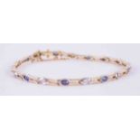 An 18ct yellow & white gold link bracelet set with 9 marquise cut sapphires approx. 0.58 carats in