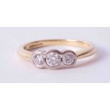 An 18ct yellow & white gold three stone ring set with approx. 0.37 carats total weight of round