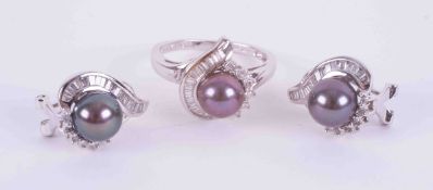 A 14k white gold swirl design ring set a black cultured pearl (approx. 7.4mm) surrounded by a