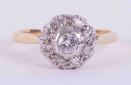 An 18ct yellow & white gold flower style cluster ring set with approx. 0.15 carats of round cut