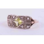 A 14ct rose and white gold Art Deco ring set with approx. 1.00 carat of square cut peridot and eight