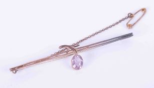 A 9ct rose gold bar brooch set with an oval amethyst approx. 0.60 carats in size, with safety chain,