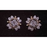 A pair of 9ct yellow gold flower design earrings set 0.34 carats (total weight) of round cut