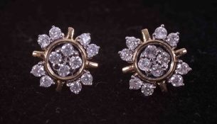 A pair of 9ct yellow gold flower design earrings set 0.34 carats (total weight) of round cut