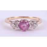 An 18ct yellow gold & platinum three stone ring set with a round cut pink sapphire or ruby? (