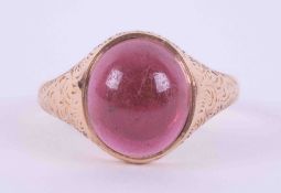 A 15ct rose gold signet style ring set with a cabochon cut red stone measuring approx. 10.4mm x 9mm,