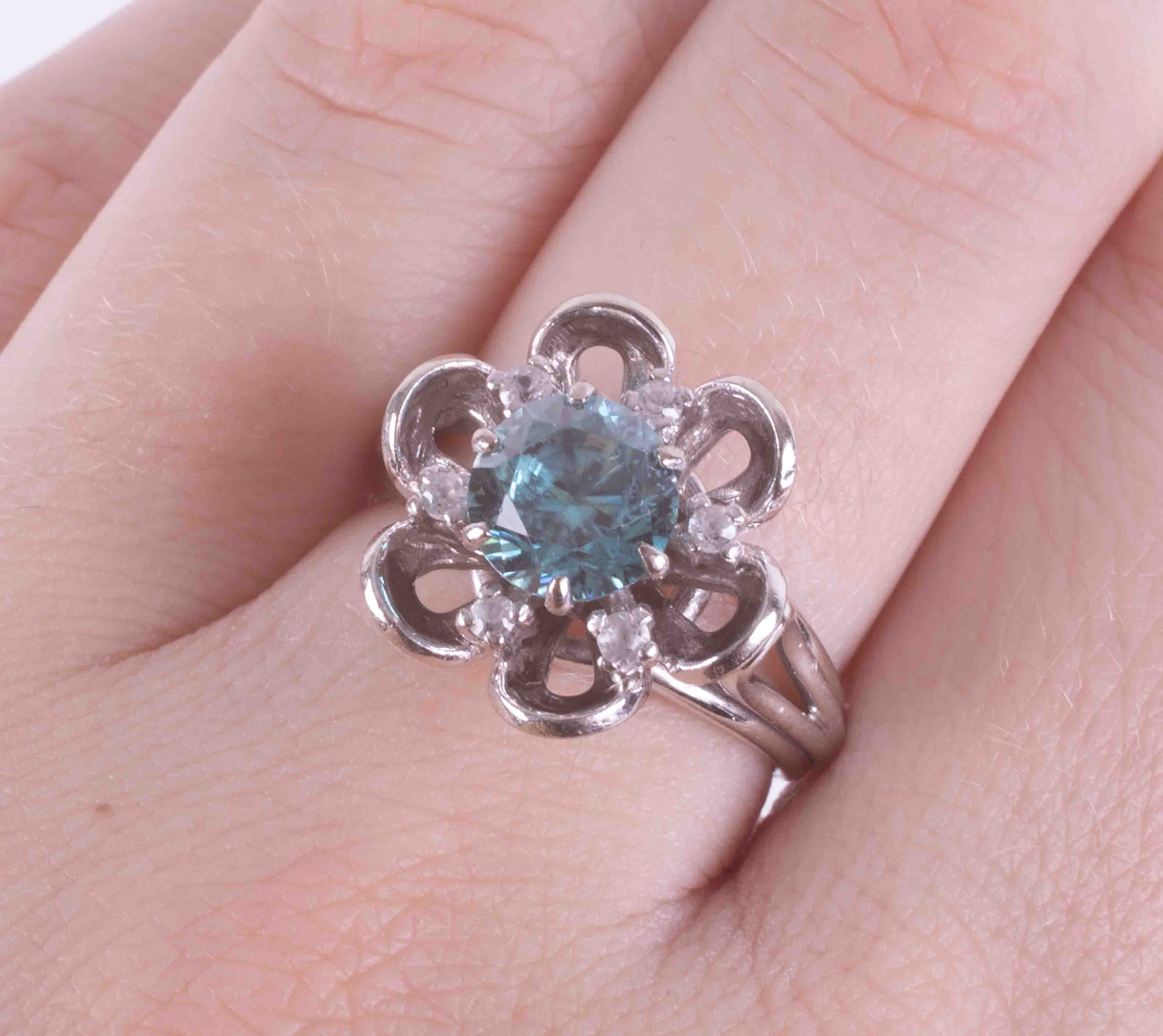 A 14ct white gold flower ring set with a central round cut blue zircon, approx. 1.47 carats, - Image 2 of 2
