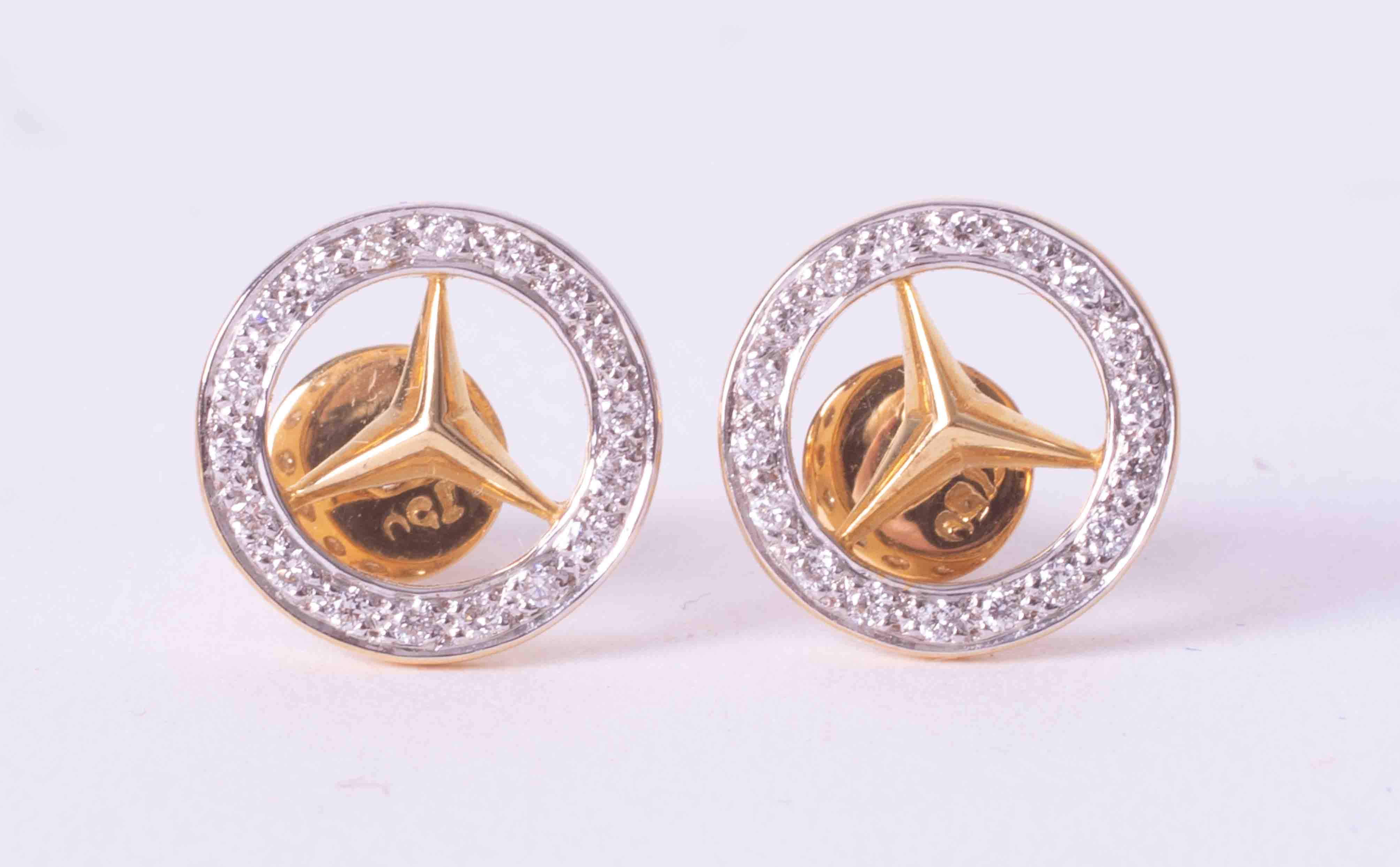 A pair of 18ct yellow & white gold Mercedes Benz earrings set with an outer circle of small round