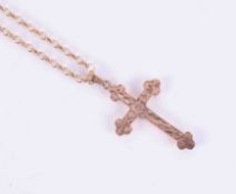 A 9ct yellow gold 16" belcher chain with a 9ct rose gold flower engraved cross, length including